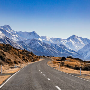 Beautiful photo of the road leading up to the snowy mountain range around Mount Cook.