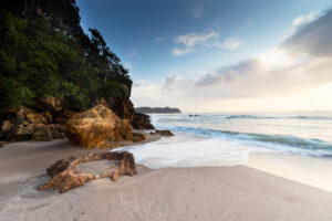 Waves washing up on the sand at Hot Water Beach in the Coromandel.